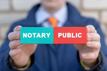 Businessman presents colorful blocks with inscription: NOTARY PUBLIC. Notary public service concept.