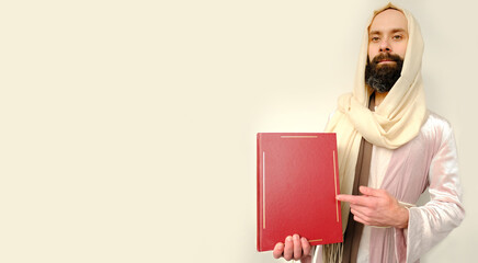 holy book of Christians, bible in red cover in hands of Jesus Christ Hand ask for follow or...