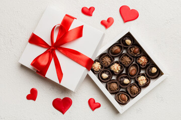 Delicious chocolate pralines in red box for Valentine's Day. Heart shaped box of chocolates top view with copy space