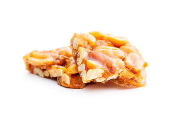 Sweet peanut brittle. Tasty peanuts in caramel isolated on white background. - obrazy, fototapety, plakaty