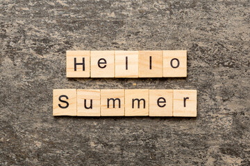 Hello Summer word written on wood block. Hello Summer text on cement table for your desing, concept