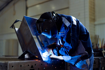 Engineering welder working in metal factory. Metal welding specialist.