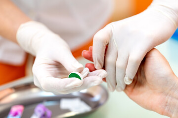 Nurse taking blood in modern hospital ward. Blood laboratory collecting.