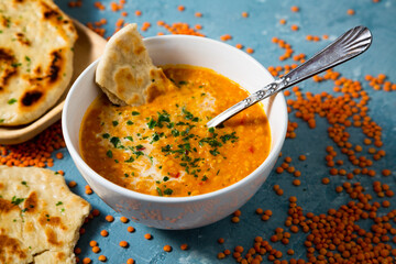Homemade red lentil soup with naan bread