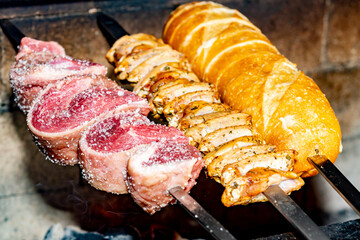 Authentic Brazilian churrasco, with picanha, garlic bread and galeto. Selective focus