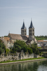 Fototapeta na wymiar Beautiful view of River Seine Banks with Collegiate Church of Notre-Dame (founded between 1016 and 1031). Melun, Seine-et-Marne department, Ile-de-France region, France.