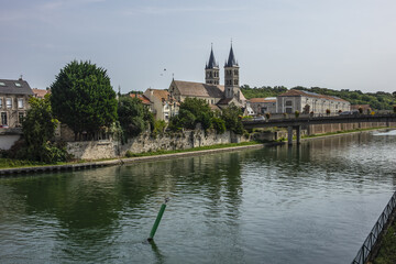 Fototapeta na wymiar Beautiful view of River Seine Banks with Collegiate Church of Notre-Dame (founded between 1016 and 1031). Melun, Seine-et-Marne department, Ile-de-France region, France.