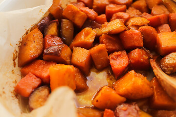 diced sweet potato baked in the oven on a baking sheet