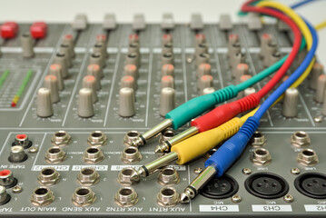 Multicolor audio jacks on music mixing console for connecting music devices