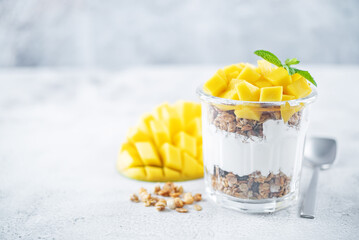 Mango Greek yogurt granola parfait in a glass