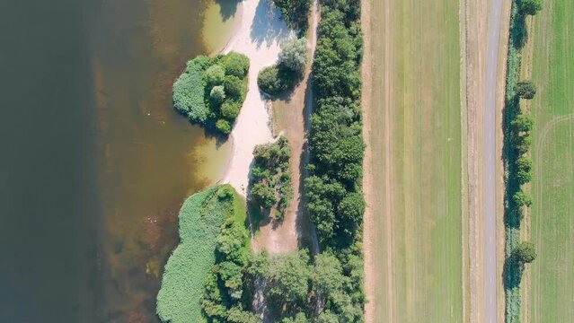 Aerial top down drone shot of a lake and a beach in Zeewolde, The Netherlands