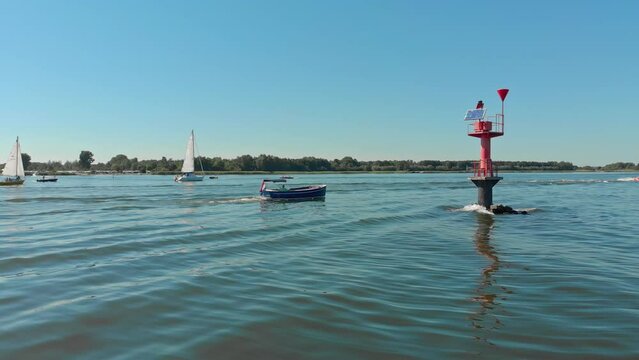 Aerial drone shot of a boat on a lake in Zeewolde, The Netherlands
