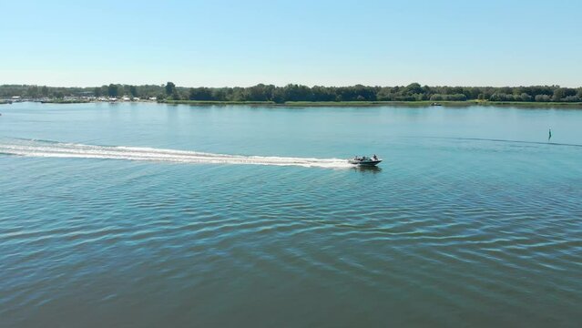 Aerial tracking drone shot of a speedboat on a lake in Zeewolde, The Netherlands
