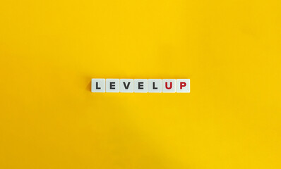 Level Up Banner. Letter Tiles on Yellow Background. Minimal Aesthetics.