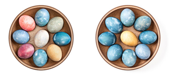 Different easter eggs in ceramic bowl on white