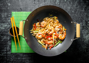 Delicious Chinese Udon noodles with shrimp, sauce and vegetables.