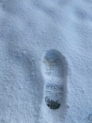 human foot print on the white layer of snow