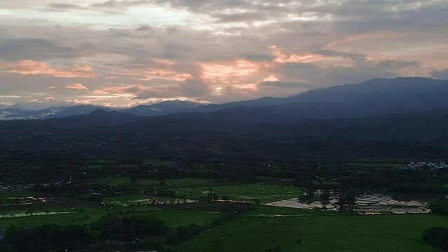 sunset reflection on rice fields over the mountains aerial view of jamundi valle del cauca