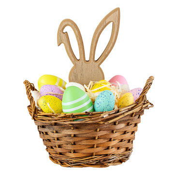 Basket with colourfull Easter eggs and bunny figure isolated on white