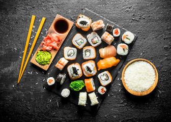 The range of different types of sushi, rolls and Maki with sauces and chopsticks.