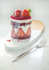 Red cake with strawberries. Strawberry dessert with cream. Sweet strawberry pie isolated on white.