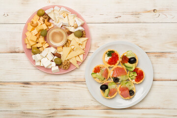 Different tasty snacks for party on wooden background, top view