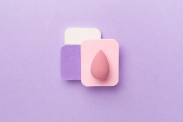 Beauty blenders on color background, top view
