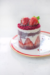 Red cake with strawberries. Strawberry dessert with cream. Sweet strawberry pie isolated on white.