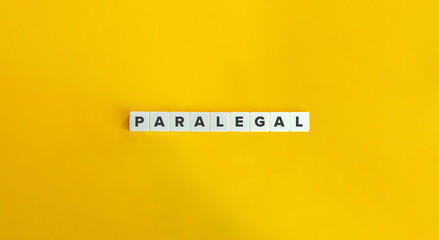 Paralegal Word on Block Letter Tiles on Yellow Background. Minimal Aesthetics.