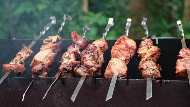 Cooking shish kebab on the grill. Cooking marinated meat on coals. Cooking meat on coals.