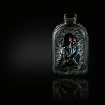 A drunk alcoholic addicted man trapped inside a liquor bottle isolated on black background with reflection and copy space, generative AI
