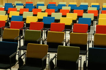 Straight rows of colourful chairs in the hall