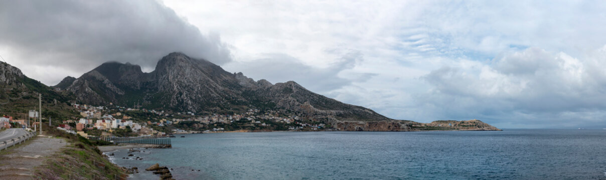 View of the mountain called Jebel Musa, also known as La Mujer Muerta (The Dead Woman), at its feet the Moroccan village of Belyounech and in front the fence separating Ceuta (Spain) and Morocco.