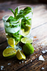 summer coctail background with fresh Mojito over rustic wooden background