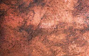 Rust colored concrete wall with black mildew stains grunge texture