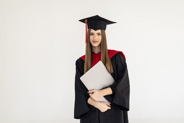 Female young graduating student with laptop on white background
