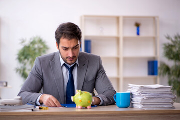 Young male employee in planning retirement concept