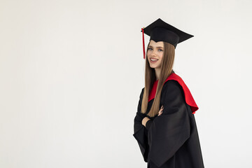 Graduate womanwith master degree in black graduation robe and cap on white background. Happy young...