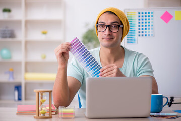 Young male designer sitting in the office