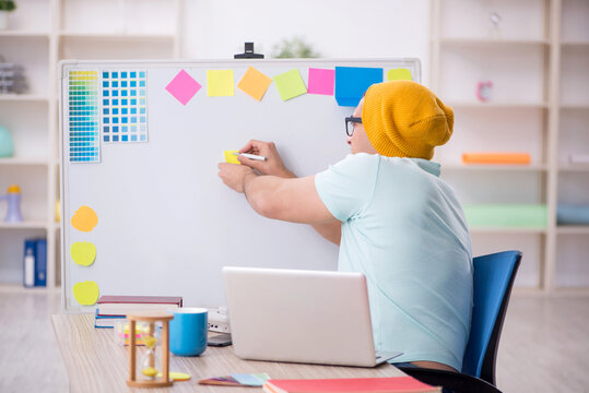 Young male designer sitting in the office - Powered by Adobe