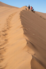 Fototapeta na wymiar Hiking on sand dunes around Deadvlei in Sossusvlei, Namibia, Africa