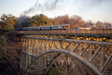 The Victoria Falls Steam Train on the Victoria Falls Bridge between Zimbabwe and Zambia, Africa - obrazy, fototapety, plakaty