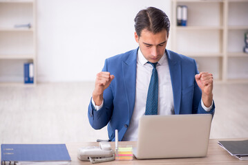 Young male employee working in the office