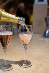 Tasting of rose champagne sparkling wine produced by traditional method in underground caves in Champagne, France