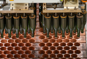 Production of cremant sparkling wine in Burgundy, France. Automatically powered bottling and riddling lines on factory.