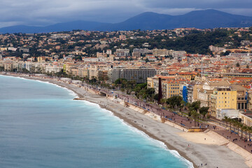 Sandy Beach by Historic City of Nice, France. View from Castle Hill. Cloudy Evening before Sunset.