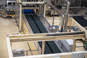 Production of cremant sparkling wine in Burgundy, France. Automatically powered bottling lines on factory.