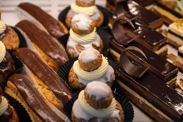 Assortment of french fresh baked sweet pastry with fresh fruits and berries in confectionery shop