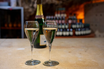 Tasting of rose champagne sparkling wine produced by traditional method in underground caves in Champagne, France