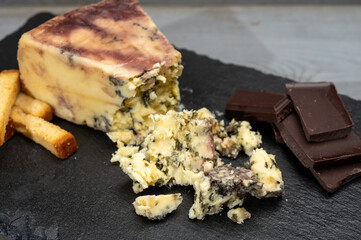 Cheese collection, blue stilton English cheese matured in red porto wine served as dessert with walnuts and chocolate